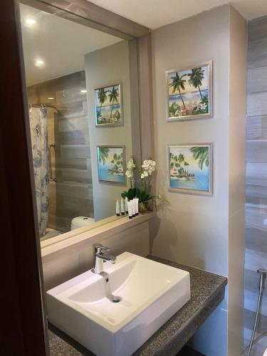 a bathroom with a sink and a mirror at Studio Deluxe @ Sta.Lucia East Grand Mall - Hotel & Residences in Manila