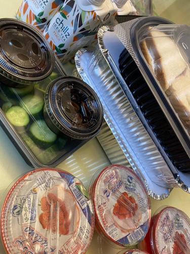 a table with plates of food and a piano at The royal cottage Amman in Al Qasţal