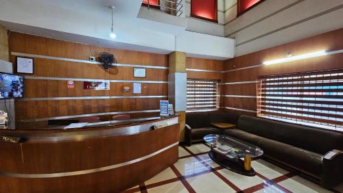 a waiting room with a couch and a table at Deira City Residency in Kāsaragod