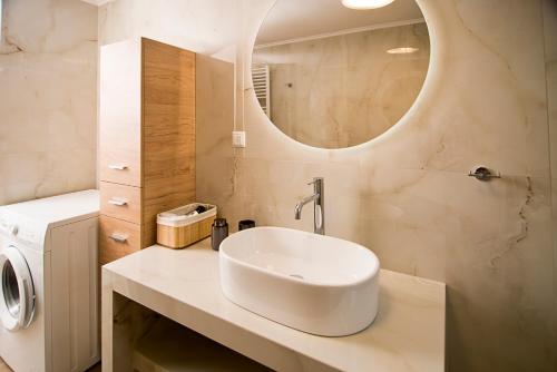 a bathroom with a sink and a mirror at Dream apartment next to the sea in Kyparissia