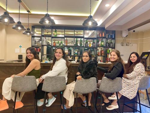 a group of women sitting in front of a bar at Shomo Chuki Resort in Paro