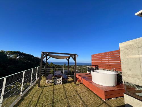 a balcony with a tub and a gazebo at -Musée Villa- in Nakijin