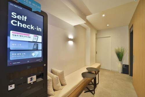 a waiting room with a sit check in sign at Hotel Yam Yeonsan in Busan