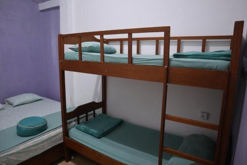a couple of bunk beds in a room at The view padang, Amazing view, 8 mins Mentawai fast ferry, cold beer,close to restaurants in Padang