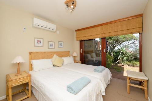 a bedroom with a large white bed and a window at San Lameer Villa 14117 - 3 Bedroom Superior - 6 pax - San Lameer Rental Agency in Southbroom