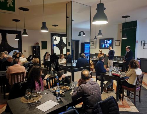 a group of people sitting at tables in a restaurant at Albanuova Hotel in Reggio di Calabria