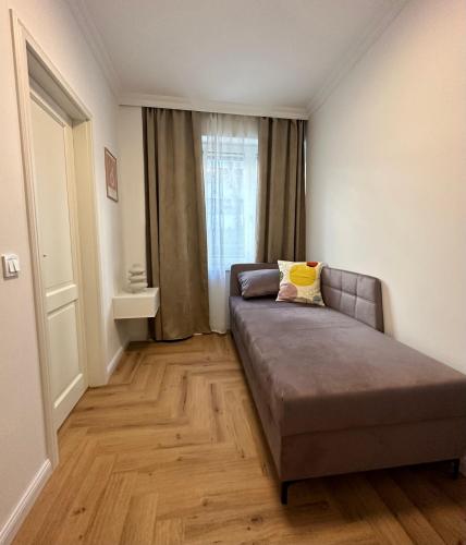 a bedroom with a couch in a room with a window at MIRABELLE Homes in Salzburg
