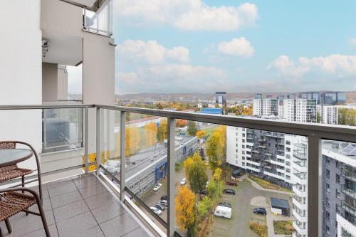 an apartment balcony with a view of a city at Spacious Apartment Aleja Rzeczypospolitej with Balcony by Noclegi Renters in Gdańsk