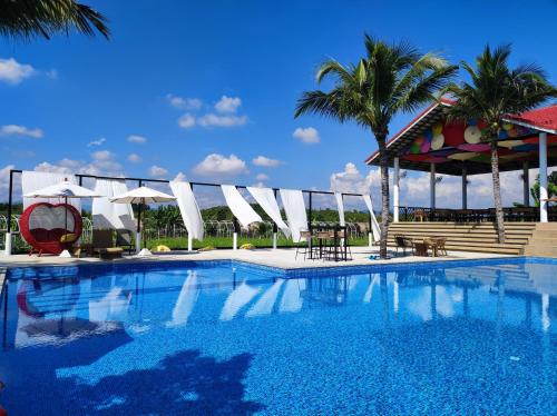 a swimming pool with chairs and a gazebo at Home at 9 in Ban Klang (4)