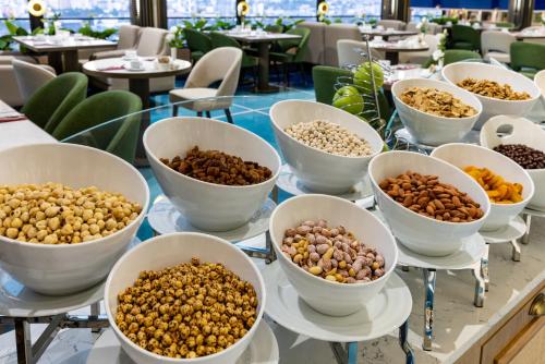 a table topped with bowls of nuts and beans at Clarion Hotel Golden Horn in Istanbul