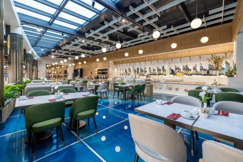 a restaurant with blue floors and tables and chairs at Clarion Hotel Golden Horn in Istanbul