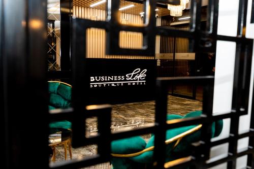 a gate with green chairs in a room at Business Life Hotel & SPA Bakırköy in Istanbul