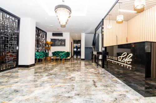 a lobby of a store with chairs and a table at Business Life Hotel & SPA Bakırköy in Istanbul