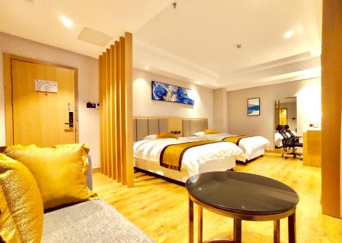 a hotel room with two beds and a couch at Zhangjiajie ViVi Boutique Hotel in Zhangjiajie