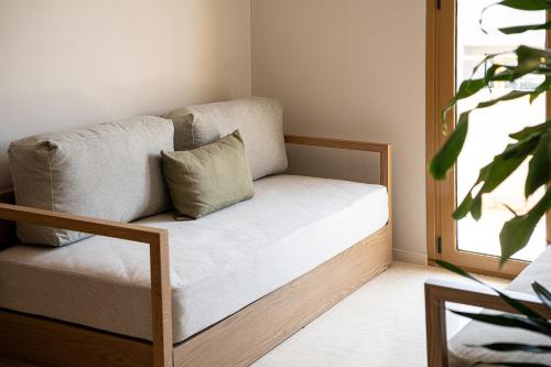 a couch sitting in a room with a window at Esperides Beach Hotel Apartments in Stalos