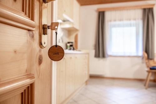 a close up of a wooden door with a tag on it at Mösslhof App Laite in San Vito
