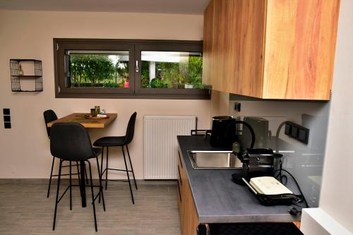 a kitchen with a counter with chairs and a sink at Hilltop house in Ioannina