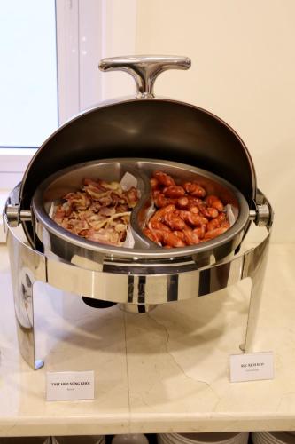 a pan filled with food on a table at Iris Dalat Hotel in Da Lat