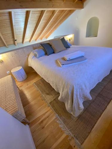 a bedroom with a large bed in a room at Casa da Corredoura in Évora
