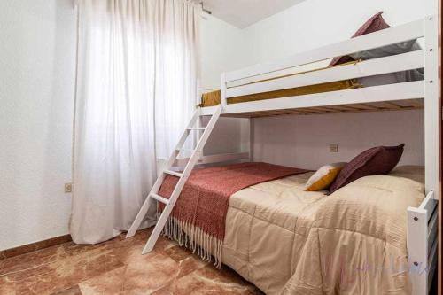 a bedroom with a bunk bed and a ladder at A estrenar pleno centro, parking in Huelva