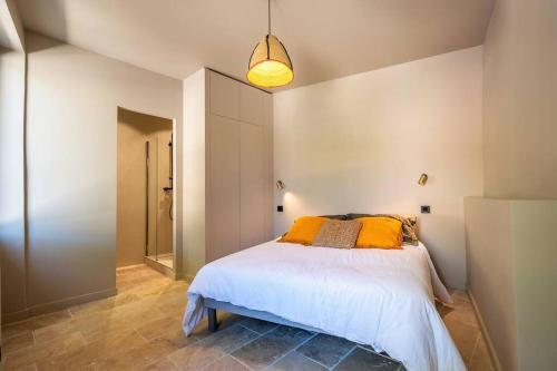 1 dormitorio con 1 cama y luz colgante en Au cœur d'Eygalières, en Eygalières