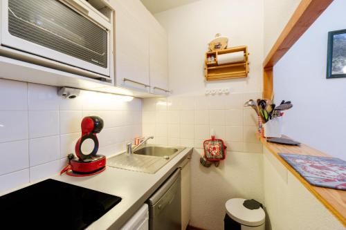 a small kitchen with a sink and a counter at L'edelweiss in Modane