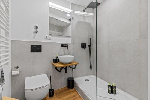 a bathroom with a shower and a toilet and a sink at ma suite -NEW-23Floor-FantasticView-Center in Augsburg