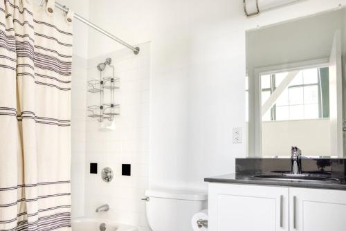 a white bathroom with a sink and a shower at Kendall Square 1BR nr MIT BOS-718 in Boston