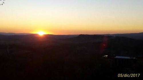a sunset with the sun setting in the distance at 8380 Miracolle apartments in Poggio Murella