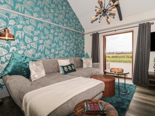 a living room with a bed and a couch at Athelney Cottage in Bridgwater