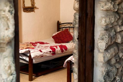 a small bed in a room with a mirror at RB Contractor Stays - Dderwen in Pwllheli