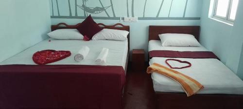 a bedroom with two beds with hearts on them at DA GREA NATURAL BEACH HOTEL in Trincomalee