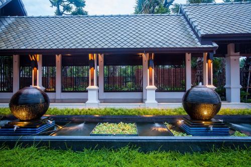 two large vases in front of a building at Huernnana Boutique Hotel in Phrae