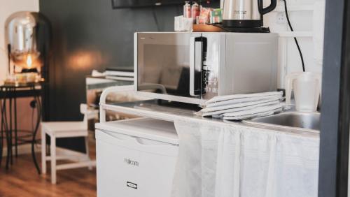 a microwave sitting on top of a kitchen counter at Tzefania Hotel in Jerusalem