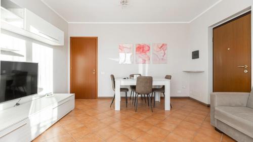 a living room with a table and a couch at Piazza Alboreto 72 - Rozzano in Rozzano