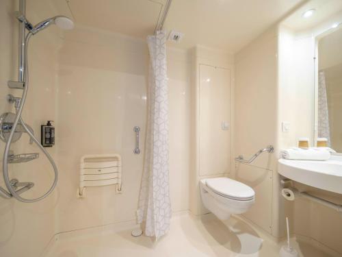 a bathroom with a shower and a toilet and a sink at ibis budget Forbach Centre in Forbach