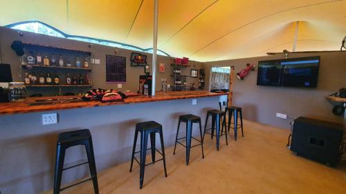 a bar with bar stools in a room at SavannaSkies Stays in Hillcrest