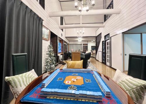 an office with a table with a blue rug on it at 虹の街22 #Nature Escape BBQ in Kita-karuizawa