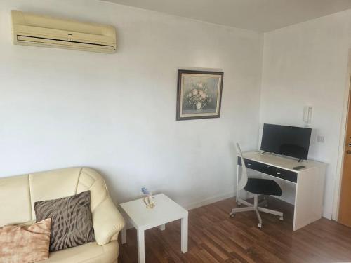 a living room with a couch and a desk with a computer at 1BDR Apartment-Aglantzia in Aglantzia