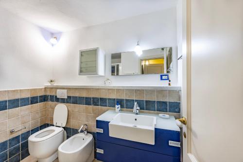 a bathroom with a toilet and a sink at Beppe's House in Garfagnana - Happy Rentals in Pescaglia