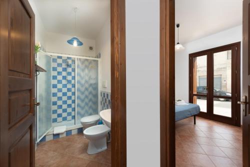 a bathroom with a toilet and a sink at I Tre Golfi - Covo dei Pirati in San Vito lo Capo