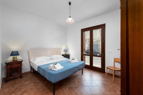 a bedroom with a bed with towels on it at I Tre Golfi - Covo dei Pirati in San Vito lo Capo