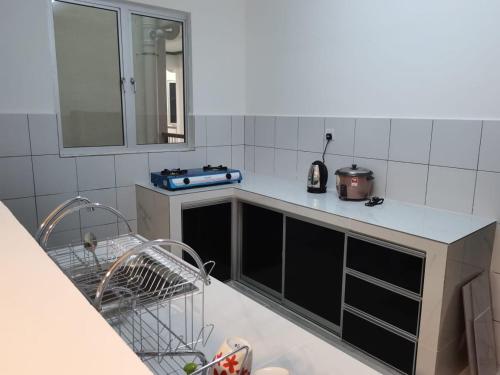 a kitchen with a sink and a dishwasher at Casa D’Bayu in Kampong Alor Gajah