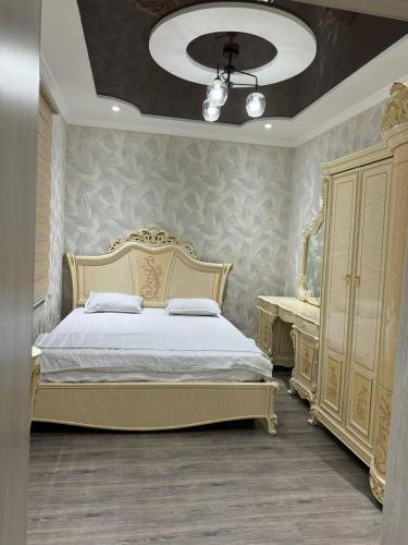a bedroom with a bed and a dresser and a mirror at Bonushka 5 in Uzbankinty