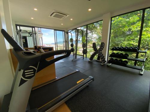 a fitness room with a gym with a treadmill at Three Monkeys Villas in Patong Beach