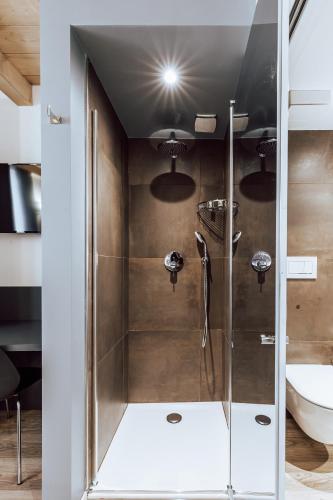 a shower with a glass door in a bathroom at Mine House in Trento
