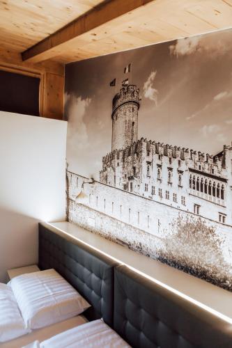 a painting of a lighthouse on a wall at Mine House in Trento