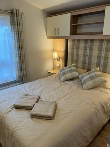 a large bed with two towels on top of it at Luxury seaside cottage 29 in Knokke-Heist