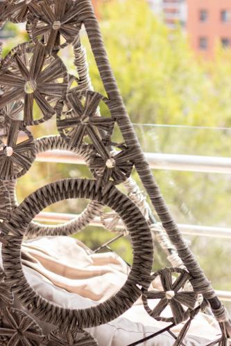 a close up of a wicker chair in front of a window at Modern apartment in Colinas de Cruzeiro in Odivelas