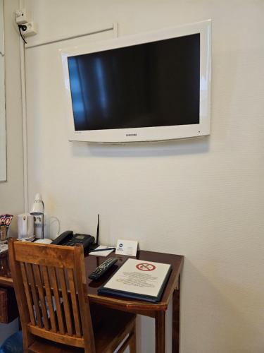 a desk with a television hanging on a wall at Best Western Hotel Apollo in Oulu